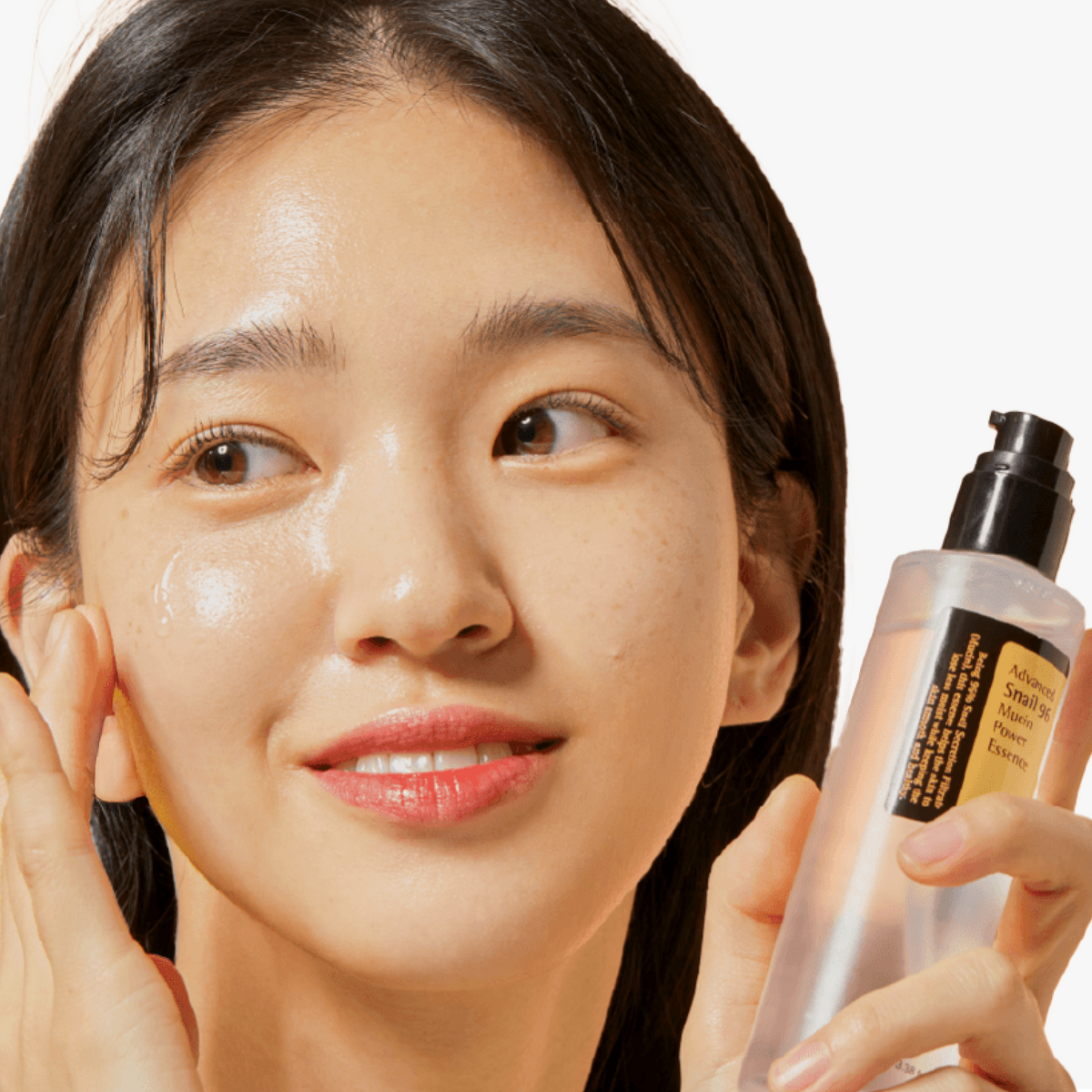 Model gently patting COSRX Advanced Snail 96 Mucin Power Essence onto face, highlighting healthy, dewy complexion; formulated with 96% snail secretion filtrate to soothe irritation, enhance glow, and maintain elasticity in hydration-focused Korean skincare.
