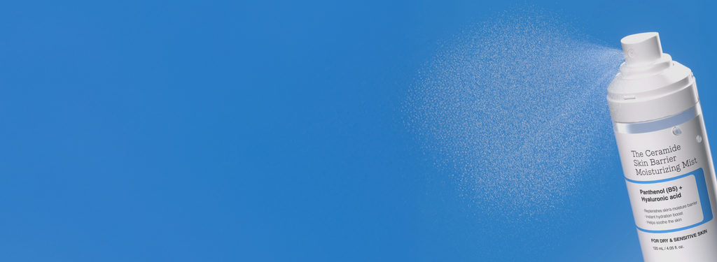 COSRX The Ceramide Skin Barrier Moisturizing Mist bottle spraying fine mist on blue background with text ‘The Ultimate Barrier-Strengthening Solution’; lightweight yet deeply hydrating Korean face mist formulated for dry and sensitive skin to reinforce barrier function and soothe dryness.